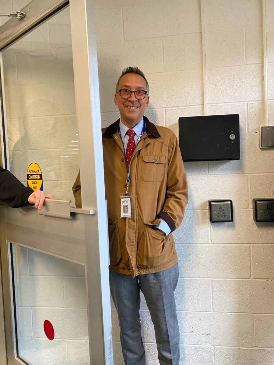 Mr. Schaperjahn joyfully (and swiftly) opens doors for students! 